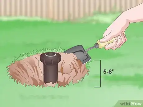 Step 2 Dig a 5–6 in (13–15 cm) deep hole around the sprinkler head.