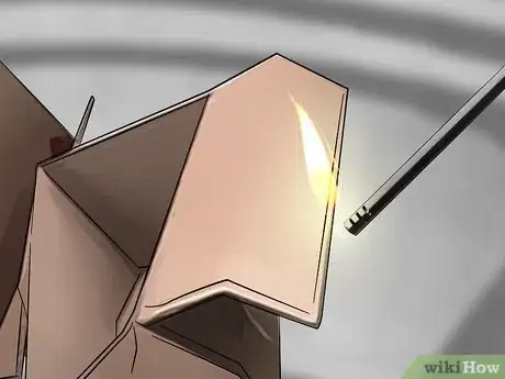Step 2 Use a long lighter or match to ignite the rubbish.