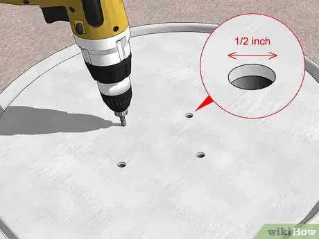 Step 3 Create 3-4 1⁄2 inch (1.3 cm) drainage holes in the bottom of the drum.