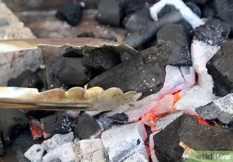 Step 2 Add coals regularly to keep your grill burning hot.